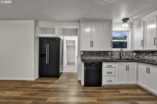 1262 Kalmia St, Junction City, OR 97448 - kitchen featuring decorative backsplash, dark countertops, white cabinets, a sink, and black appliances