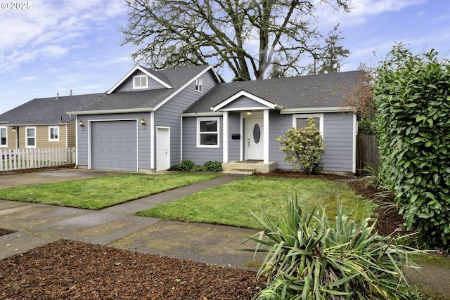 1262 Kalmia St, Junction City, OR 97448 - view of front of property with a front yard, fence, concrete driveway, an attached garage, and a shingled roof