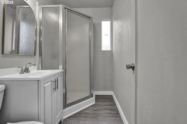 1262 Kalmia St, Junction City, OR 97448 - full bath with a shower stall, wood finished floors, vanity, baseboards, and toilet