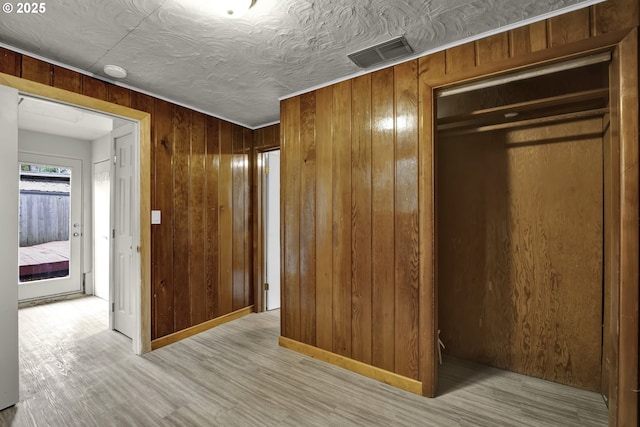 1262 Kalmia St, Junction City, OR 97448 - unfurnished bedroom with visible vents, wooden walls, a closet, and light wood-type flooring