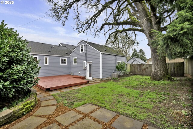 1262 Kalmia St, Junction City, OR 97448 - back of house with a fenced backyard, central AC unit, a lawn, and a deck