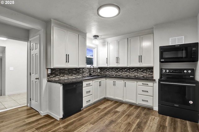1262 Kalmia St, Junction City, OR 97448 - kitchen featuring a sink, backsplash, black appliances, and visible vents