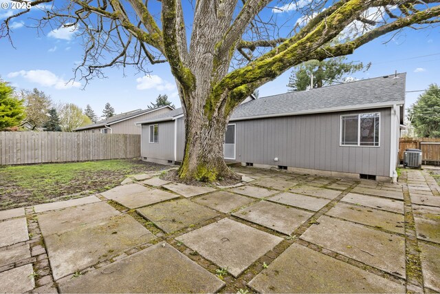 263 Ferndale Dr, Eugene, OR 97404 - back of house with central AC unit, a patio, roof with shingles, and a fenced backyard