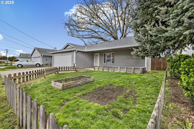 263 Ferndale Dr, Eugene, OR 97404 - view of front of property with a garage, roof with shingles, and a garden