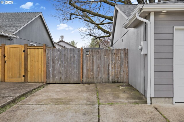 263 Ferndale Dr, Eugene, OR 97404 - view of home's exterior featuring a gate and roof with shingles