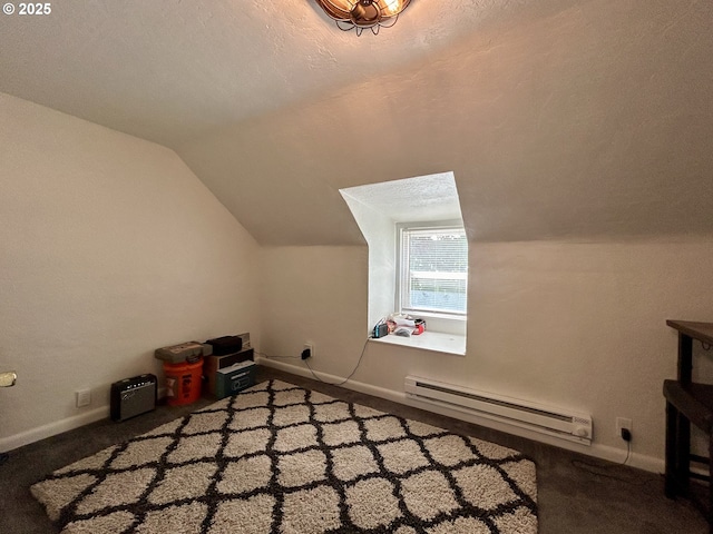 additional living space with vaulted ceiling, baseboards, and baseboard heating