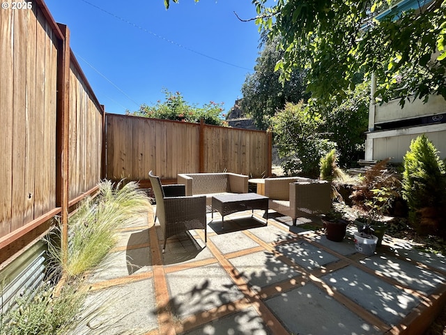 view of patio / terrace featuring an outdoor hangout area and a fenced backyard