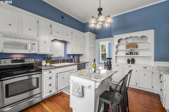 1067 Oak St, Silverton, OR 97381 - kitchen featuring stainless steel appliances, a chandelier, a sink, white cabinets, and ornamental molding