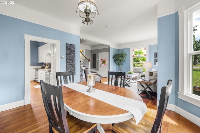1067 Oak St, Silverton, OR 97381 - dining space with stairway, baseboards, light wood-type flooring, and a chandelier