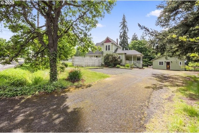 1067 Oak St, Silverton, OR 97381 - view of front of property with dirt driveway, covered porch, and an outdoor structure