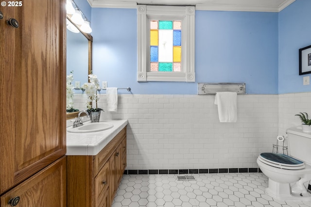 1067 Oak St, Silverton, OR 97381 - bathroom featuring tile walls, toilet, vanity, tile patterned floors, and wainscoting