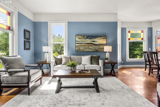 1067 Oak St, Silverton, OR 97381 - living room featuring wood finished floors, healthy amount of natural light, and baseboards