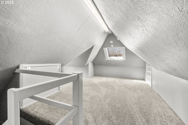 1067 Oak St, Silverton, OR 97381 - additional living space with a textured ceiling, vaulted ceiling, and carpet flooring