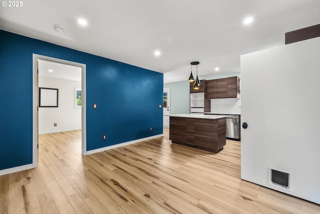 1067 Oak St, Silverton, OR 97381 - kitchen with stainless steel dishwasher, light countertops, a kitchen island, recessed lighting, and light wood-type flooring