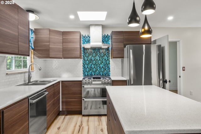 1067 Oak St, Silverton, OR 97381 - kitchen with wall chimney range hood, stainless steel appliances, a sink, a skylight, and backsplash