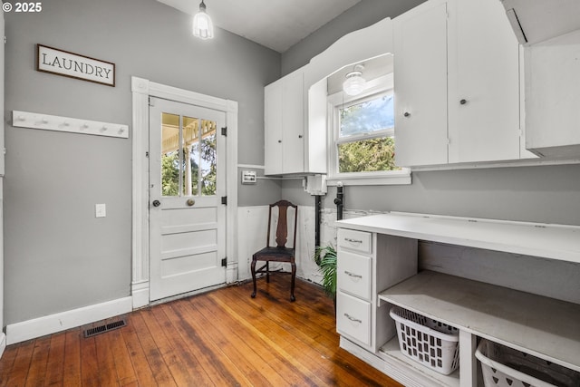 1067 Oak St, Silverton, OR 97381 - laundry area with healthy amount of natural light, baseboards, and wood-type flooring
