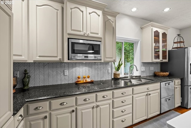 1498 Cathlamet Ct, Salem, OR 97304 - kitchen featuring stainless steel appliances, a sink, glass insert cabinets, recessed lighting, and tasteful backsplash