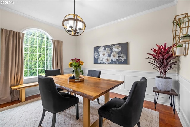 1498 Cathlamet Ct, Salem, OR 97304 - dining space with ornamental molding, a chandelier, plenty of natural light, light wood-type flooring, and a wainscoted wall