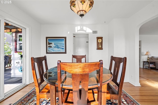 719 6th St, Astoria, OR 97103 - dining area featuring arched walkways and light wood-style floors