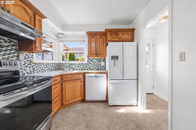 719 6th St, Astoria, OR 97103 - kitchen featuring white appliances, extractor fan, a sink, light countertops, and decorative backsplash