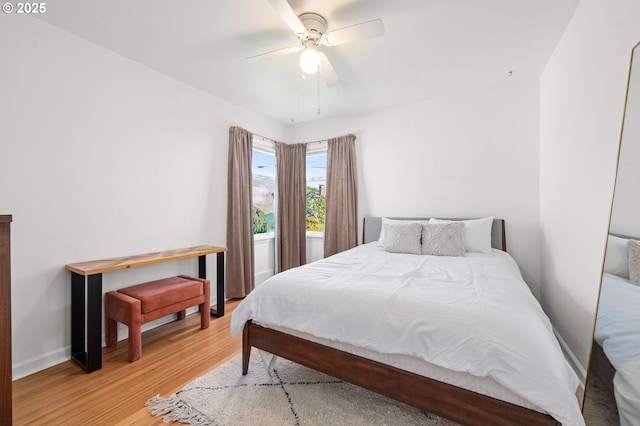719 6th St, Astoria, OR 97103 - bedroom featuring wood finished floors, baseboards, and a ceiling fan