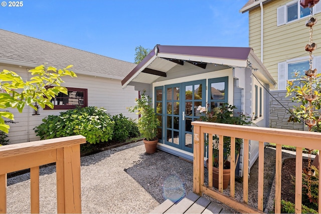 719 6th St, Astoria, OR 97103 - view of exterior entry featuring french doors and a shingled roof