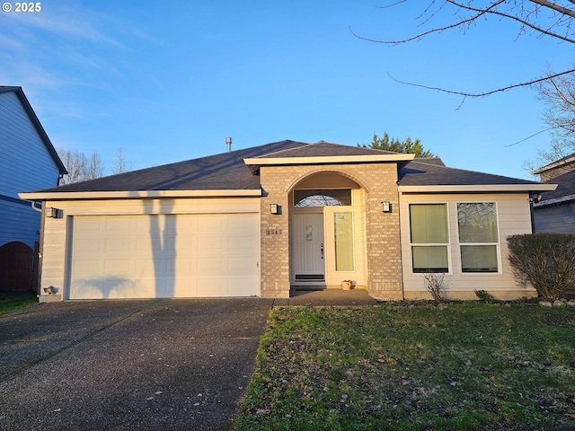 view of front of home with a garage and a front yard