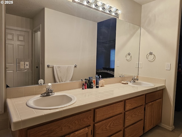 bathroom with vanity and a textured ceiling