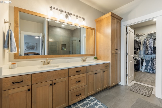 847 Pebble Crk St, Sutherlin, OR 97479 - bathroom featuring double vanity, a shower stall, a spacious closet, and tile patterned floors