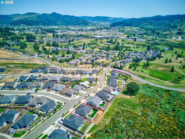 847 Pebble Crk St, Sutherlin, OR 97479 - aerial overview of property's location with property boundaries highlighted, mountains, and nearby suburban area