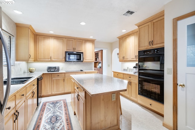 kitchen with light countertops, light brown cabinets, and black appliances