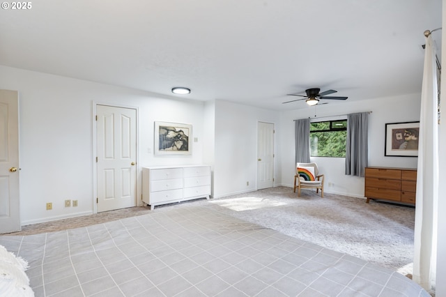 unfurnished room featuring light carpet, ceiling fan, and baseboards