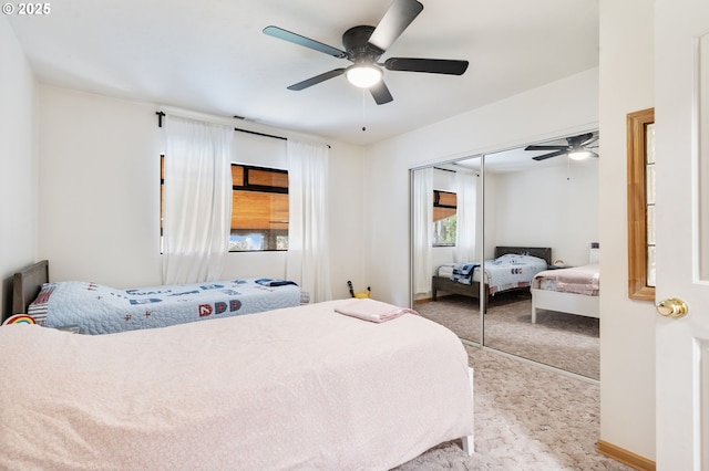 carpeted bedroom featuring baseboards, ceiling fan, visible vents, and a closet