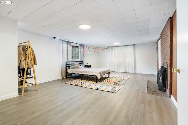 interior space with a fireplace, wood finished floors, and baseboards