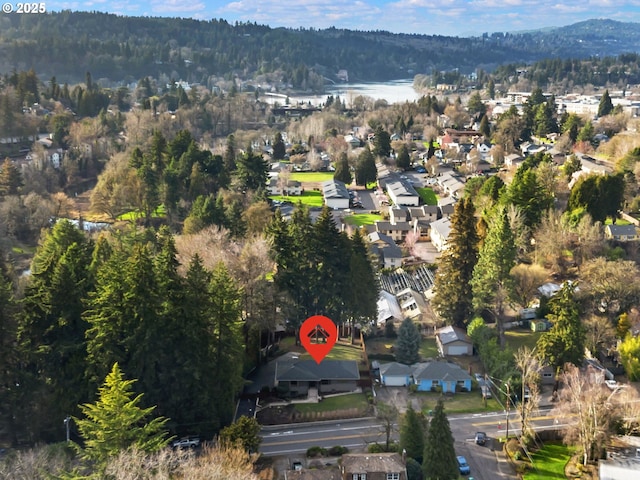 drone / aerial view featuring a residential view and a view of trees