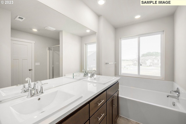 bathroom featuring recessed lighting, a garden tub, a sink, and visible vents