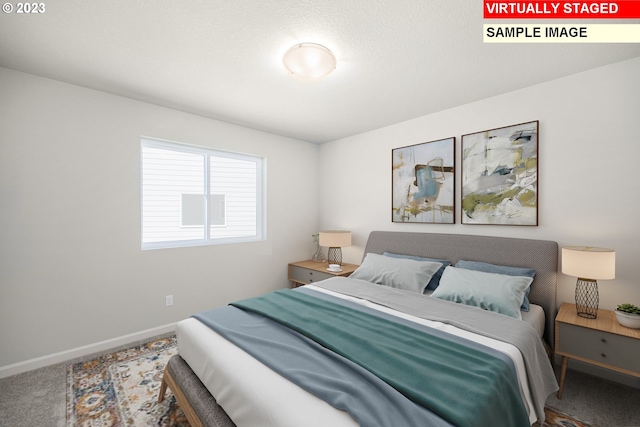 carpeted bedroom featuring baseboards