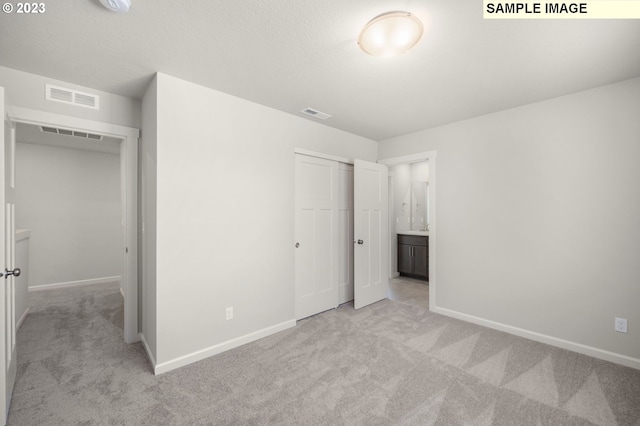 unfurnished bedroom with carpet, a closet, visible vents, and baseboards