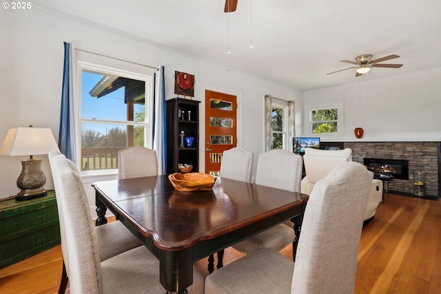 44409 SW Knight Rd, Gaston, OR 97119 - dining space featuring a ceiling fan, wood finished floors, and a stone fireplace