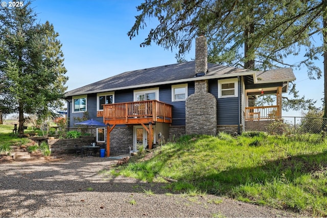 44409 SW Knight Rd, Gaston, OR 97119 - back of property with stone siding, a chimney, and a wooden deck