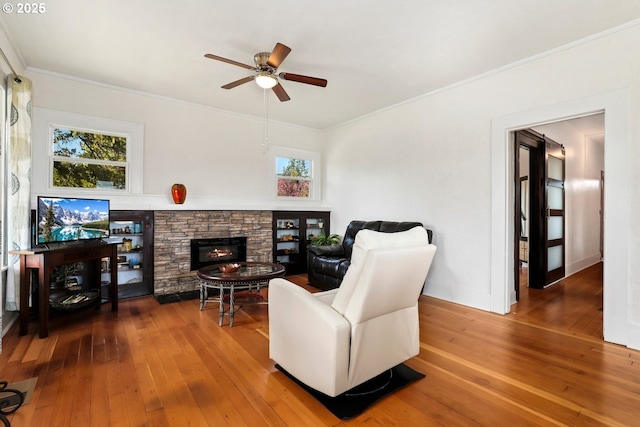 44409 SW Knight Rd, Gaston, OR 97119 - living area with ceiling fan, hardwood / wood-style floors, crown molding, and a fireplace