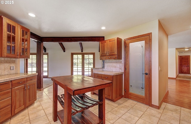 46135 E Avery Rd, Chehalis, WA 98532 - kitchen featuring brown cabinetry, backsplash, glass insert cabinets, and recessed lighting