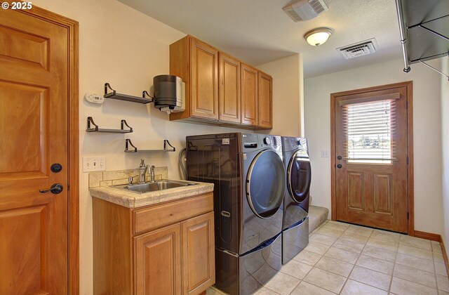 46135 E Avery Rd, Chehalis, WA 98532 - washroom featuring washing machine and clothes dryer, cabinet space, visible vents, and a sink