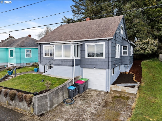 view of front of home with a garage and a front lawn