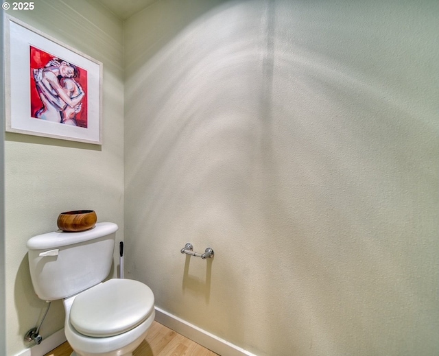 bathroom featuring hardwood / wood-style floors and toilet