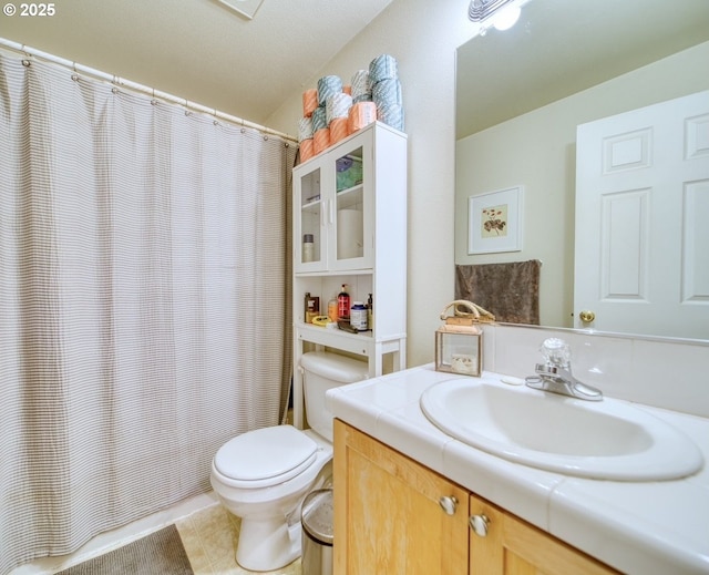 bathroom featuring vanity, toilet, and tile patterned flooring