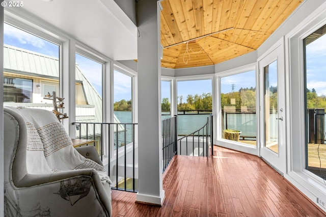 dining room with ceiling fan, baseboards, wooden ceiling, vaulted ceiling with beams, and hardwood / wood-style flooring