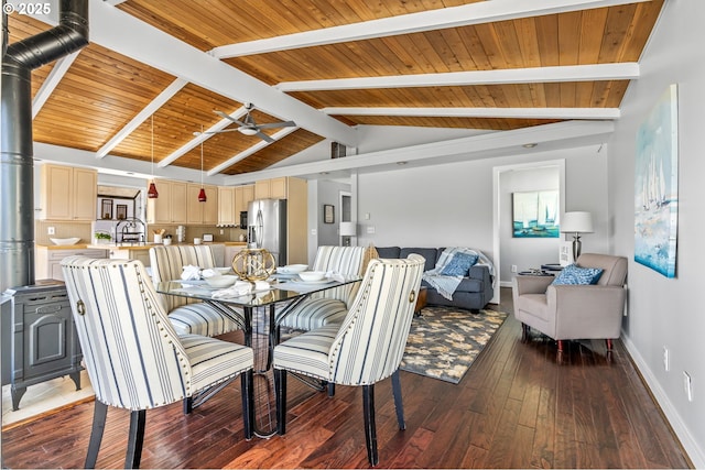 sunroom featuring a water view and beamed ceiling