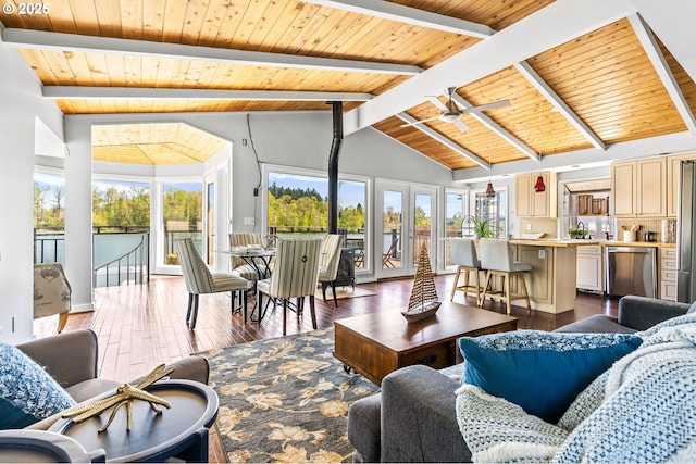 living area featuring wooden ceiling, baseboards, beamed ceiling, and wood finished floors