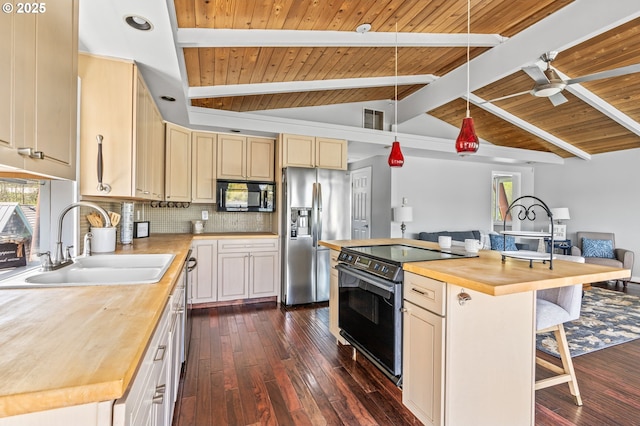kitchen featuring tasteful backsplash, stainless steel appliances, butcher block counters, and cream cabinetry